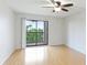 Well-lit bedroom features laminate wood flooring, ceiling fan and balcony access at 6124 43Rd W St # 404A, Bradenton, FL 34210