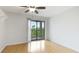 Spacious bedroom with laminate wood flooring and a sliding glass door to a balcony at 6124 43Rd W St # 404A, Bradenton, FL 34210
