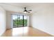 Bedroom features laminate floors and sliding door to balcony with a view at 6124 43Rd W St # 404A, Bradenton, FL 34210