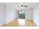 Open bedroom featuring a ceiling fan, balcony and laminate flooring at 6124 43Rd W St # 404A, Bradenton, FL 34210
