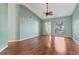 Bright living area with hardwood floors, vaulted ceilings, and a large arched window for natural light at 634 Sugarwood Ct, Venice, FL 34292