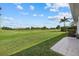 Picturesque backyard boasts a beautiful green lawn and tropical landscaping views at 6766 Greenview Ln, Englewood, FL 34224