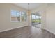 Sunlit dining area with wood floors, chandelier, window shutters, and access to a screened lanai at 6766 Greenview Ln, Englewood, FL 34224