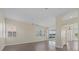 Spacious living room boasts wood-look floors, ceiling fan and access to outdoor patio at 6766 Greenview Ln, Englewood, FL 34224