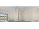 Bright living room with a ceiling fan, wood floors, and sliding doors to a screened lanai at 6766 Greenview Ln, Englewood, FL 34224