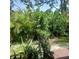 View of backyard featuring lush plants and trees at 7183 Wood Creek Dr # 9, Sarasota, FL 34231