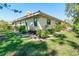 Well-maintained backyard featuring a lush lawn, mature landscaping, and the home's exterior at 7183 Wood Creek Dr # 9, Sarasota, FL 34231