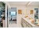 Bathroom with double vanity, large mirror, and walk-in shower with glass door at 7183 Wood Creek Dr # 9, Sarasota, FL 34231