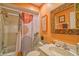 Bright bathroom featuring modern vanity, decorative mirror, and a stylish shower curtain at 7183 Wood Creek Dr # 9, Sarasota, FL 34231