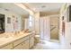 Bright bathroom featuring a spacious vanity, walk-in shower with a glass door, and tiled floors at 7183 Wood Creek Dr # 9, Sarasota, FL 34231