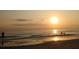 Sunset view of people on the beach with peaceful waves at 7183 Wood Creek Dr # 9, Sarasota, FL 34231