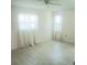 Well-lit bedroom featuring tile flooring and large windows with sheer white curtains at 7183 Wood Creek Dr # 9, Sarasota, FL 34231