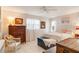 Bright bedroom with white walls, tiled floors, chest of drawers, and queen bed at 7183 Wood Creek Dr # 9, Sarasota, FL 34231