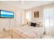 Cozy bedroom with neutral tones, a full bed, and bright natural light from two windows at 7183 Wood Creek Dr # 9, Sarasota, FL 34231