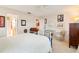 Spacious bedroom boasts white walls, tiled floors, comfortable bedding, and ensuite bath at 7183 Wood Creek Dr # 9, Sarasota, FL 34231
