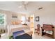 Comfortable bedroom features ensuite bath, tiled floor, queen bed, and chest at 7183 Wood Creek Dr # 9, Sarasota, FL 34231