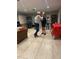 Spacious common area with tile floors, guitarist, tables, and people dancing and enjoying themselves at 7183 Wood Creek Dr # 9, Sarasota, FL 34231