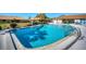 Community pool surrounded by lounge chairs and well-maintained landscaping at 7183 Wood Creek Dr # 9, Sarasota, FL 34231