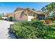 Charming single-story home featuring a well-manicured lawn, attached garage, and an American flag at 7183 Wood Creek Dr # 9, Sarasota, FL 34231