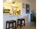 Cozy view of the kitchen with a breakfast bar, decorative artwork, and cabinetry at 7183 Wood Creek Dr # 9, Sarasota, FL 34231
