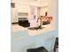 Bright kitchen features breakfast bar, stainless steel sink, tile backsplash, and white appliances at 7183 Wood Creek Dr # 9, Sarasota, FL 34231