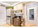 Functional kitchen with stainless steel refrigerator, wine rack, storage, and adjacent laundry area at 7183 Wood Creek Dr # 9, Sarasota, FL 34231