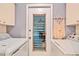 Practical laundry room with washer and dryer, featuring a decorative macrame wall hanging at 7183 Wood Creek Dr # 9, Sarasota, FL 34231