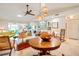 Open floor plan features a living room with tiled floors, high ceilings, and modern lighting at 7183 Wood Creek Dr # 9, Sarasota, FL 34231