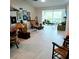 Bright living room boasts large windows and tiled floors at 7183 Wood Creek Dr # 9, Sarasota, FL 34231