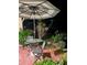 Outdoor patio with table, chairs, umbrella, and decorative plants at 7183 Wood Creek Dr # 9, Sarasota, FL 34231