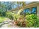 Home exterior with lush tropical landscaping in planters and ground cover around the house at 7183 Wood Creek Dr # 9, Sarasota, FL 34231