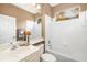 Bright bathroom with vanity, shower-tub, and decorative seashell accents above toilet at 7351 Meeting St, Bradenton, FL 34201