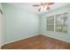 Empty bedroom with hardwood floor, ceiling fan and natural light from a single window at 7351 Meeting St, Bradenton, FL 34201