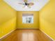 Bright yellow room with hardwood floor and a ceiling fan, offering a comfortable and airy atmosphere at 7351 Meeting St, Bradenton, FL 34201