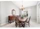 Elegant dining room with a wooden table set, vintage buffet, and chandelier lighting at 7351 Meeting St, Bradenton, FL 34201