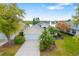 Charming home boasting lush landscaping, a two-car garage, and picturesque lake views at 7351 Meeting St, Bradenton, FL 34201
