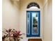 Stylish blue front door with decorative glass and transom window, enhancing curb appeal at 7351 Meeting St, Bradenton, FL 34201
