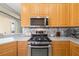 Close-up of kitchen with stainless steel appliances, gas range, and mosaic tile backsplash at 7351 Meeting St, Bradenton, FL 34201