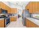Modern kitchen with stainless steel appliances, light wood cabinets, and sleek countertops at 7351 Meeting St, Bradenton, FL 34201