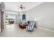 Bright living room with tile flooring, a ceiling fan, and a view of the outdoor patio at 7351 Meeting St, Bradenton, FL 34201