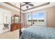 Cozy main bedroom featuring a traditional four poster bed, dresser, and lanai access at 7351 Meeting St, Bradenton, FL 34201