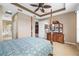 Large main bedroom with tray ceiling, adjoining bathroom, and dresser for ample storage at 7351 Meeting St, Bradenton, FL 34201