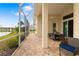 Covered screened-in patio with brick flooring overlooking a pond and landscaped yard at 7351 Meeting St, Bradenton, FL 34201