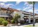 Inviting two-story condo featuring open carport and verdant landscaping at 756 Avenida Estancia # 162, Venice, FL 34292