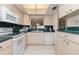 Kitchen with white appliances, countertop, and tile flooring at 756 Avenida Estancia # 162, Venice, FL 34292