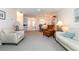 Bright living room featuring neutral tones, comfortable seating, and an open floor plan at 756 Avenida Estancia # 162, Venice, FL 34292
