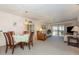 Open-concept living and dining area with neutral carpeting and a view of the outdoors at 756 Avenida Estancia # 162, Venice, FL 34292