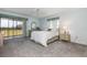 Bright bedroom featuring large windows, plush carpeting, and tranquil view from the sliding doors at 756 Avenida Estancia # 162, Venice, FL 34292