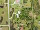 Overhead view of a large lot with a home, a pond, green trees, and surrounding parcels at 7677 Saddle Creek Trl, Sarasota, FL 34241