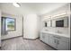 Modern bathroom with dual sinks, vanity, and a private shower at 7677 Saddle Creek Trl, Sarasota, FL 34241